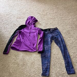 Nike Purple and Black Hoodie with Blue Leggings.